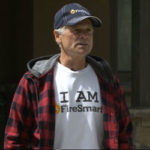 Person wearing an "I AM FireSmart" shirt and cap.