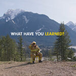 A firefighter sits on a chair in a mountainous area with the text "WHAT HAVE YOU LEARNED?" displayed above.