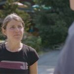 a woman speaks with someone off-camera