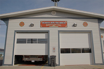 A fire station with a sign that reads "Hudson's Hope Fire Rescue Downtown Hall"