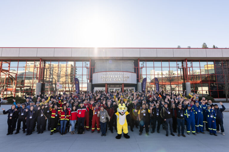 Large group of people taking a picture in front of the Prince George Conference and Civic Centre