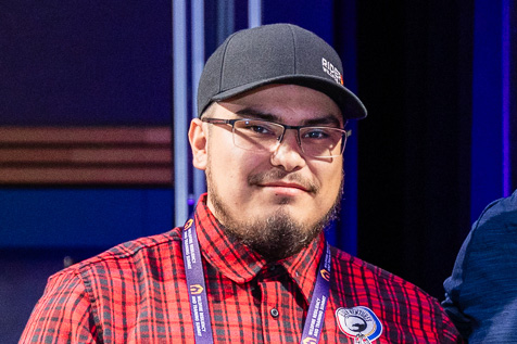 a man with glasses smiling