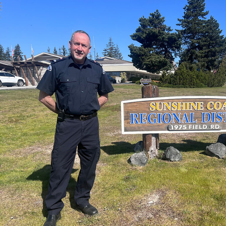 a firefighter standing in the grass