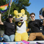 2 people with Ember the fox